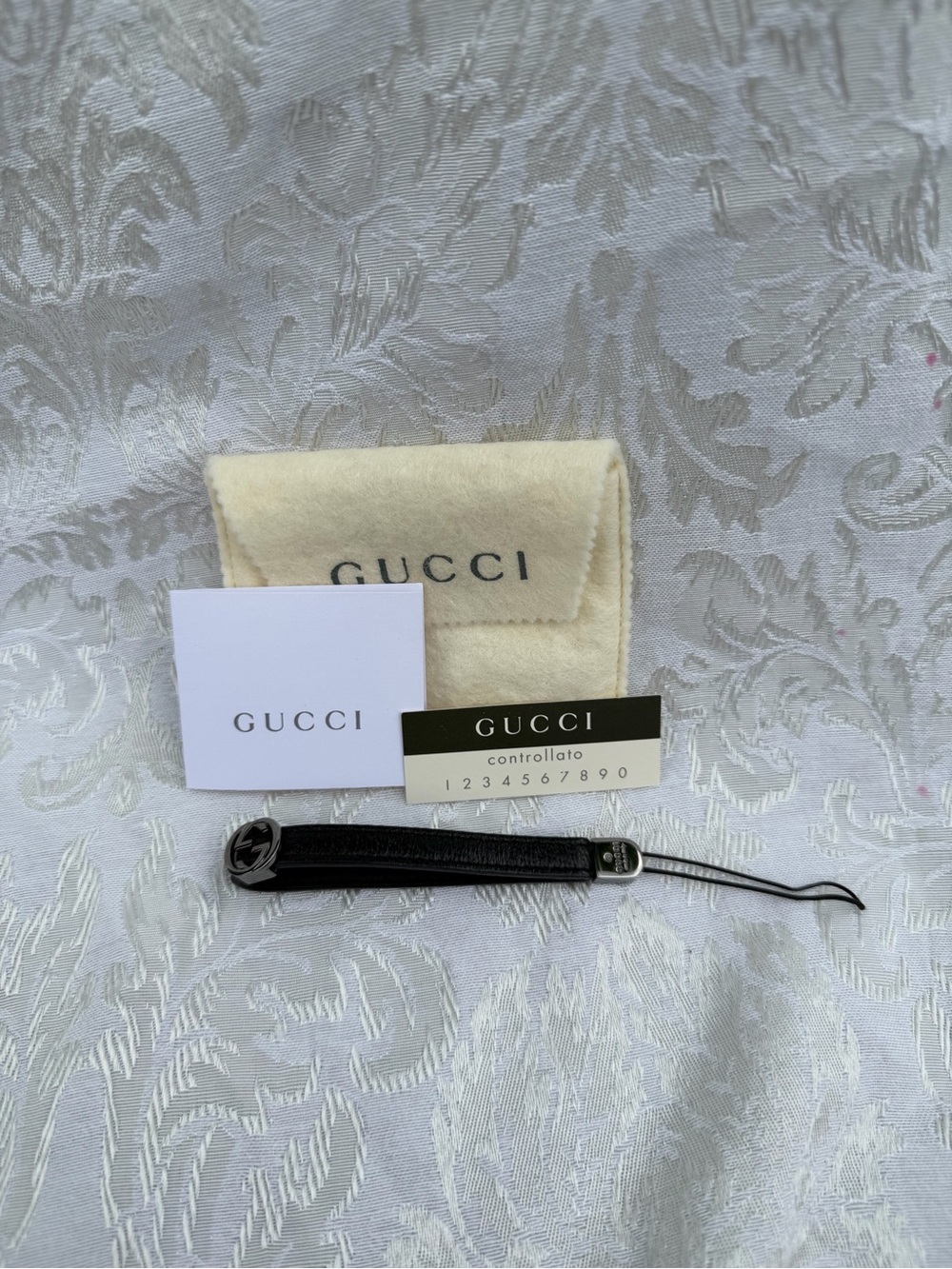 Gucci Interlocking G Leather Wrist Strap / Phone Charm